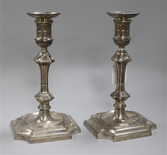 A pair of 1930s 18th century style silver candlesticks, weighted.